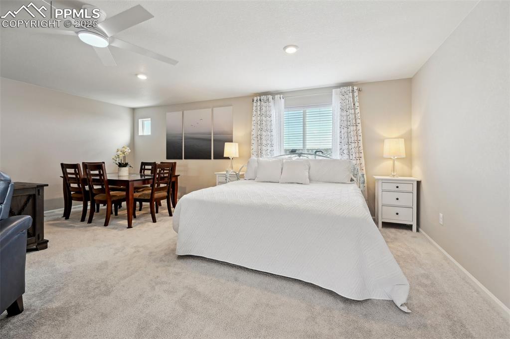 Image 26 of 44: Bedroom with multiple windows, carpet, baseboards, ceiling fan, and recesse