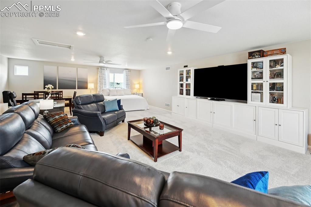 Image 30 of 44: Living area with ceiling fan, carpet, and recessed lighting