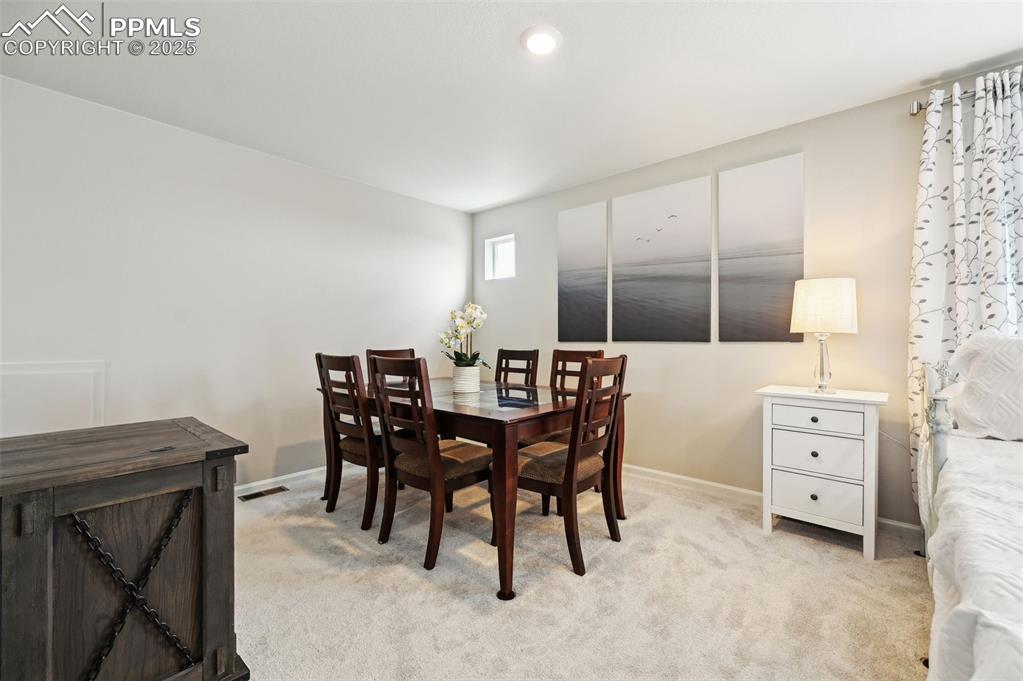 Image 31 of 44: Dining space featuring baseboards and light carpet