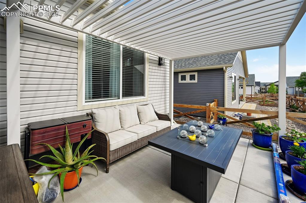 Image 34 of 44: View of patio / terrace with an outdoor hangout area and a hot tub