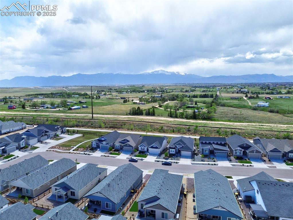 Image 41 of 44: Aerial perspective of suburban area featuring mountains