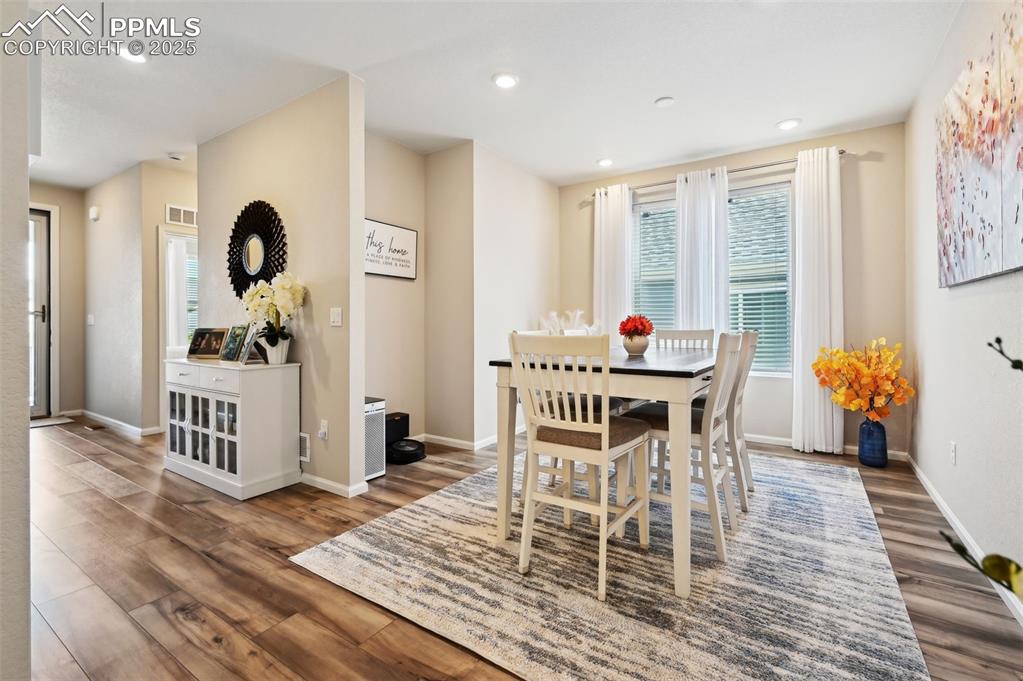 Image 5 of 44: Dining area with wood finished floors, baseboards, and recessed lighting