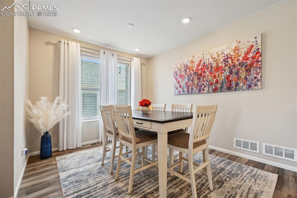 Image 6 of 44: Dining area featuring baseboards, wood finished floors, and recessed lighti