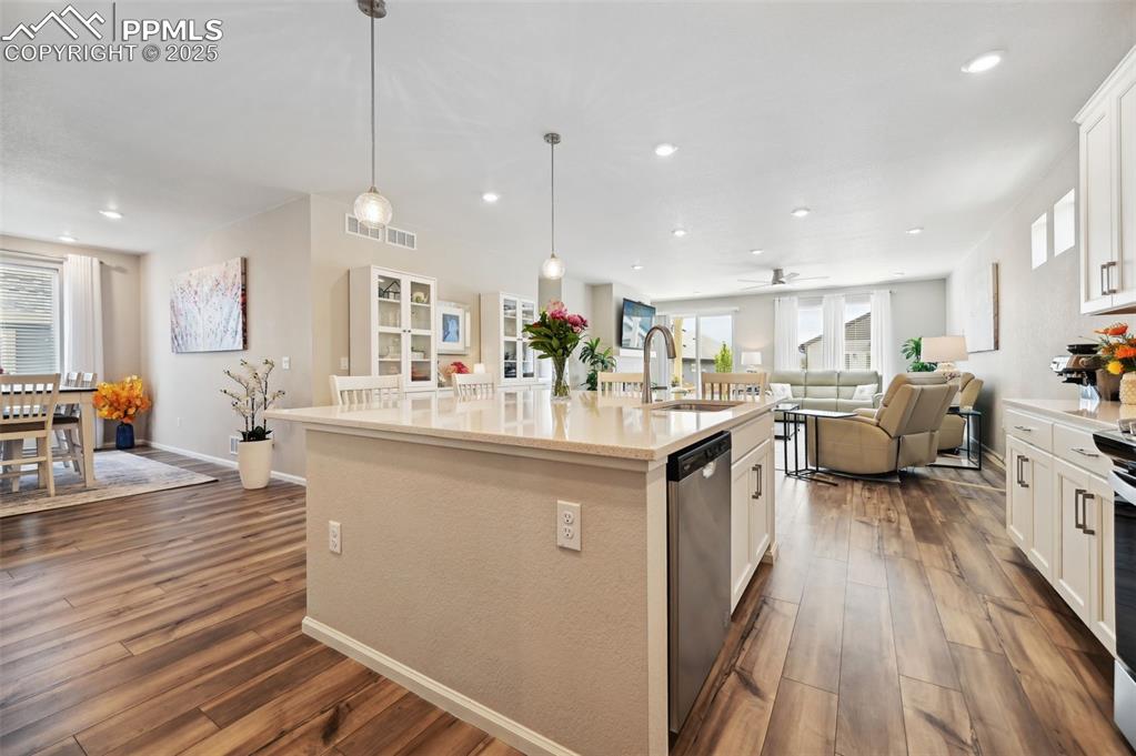 Image 7 of 44: Kitchen featuring a sink, stainless steel dishwasher, open floor plan, an i