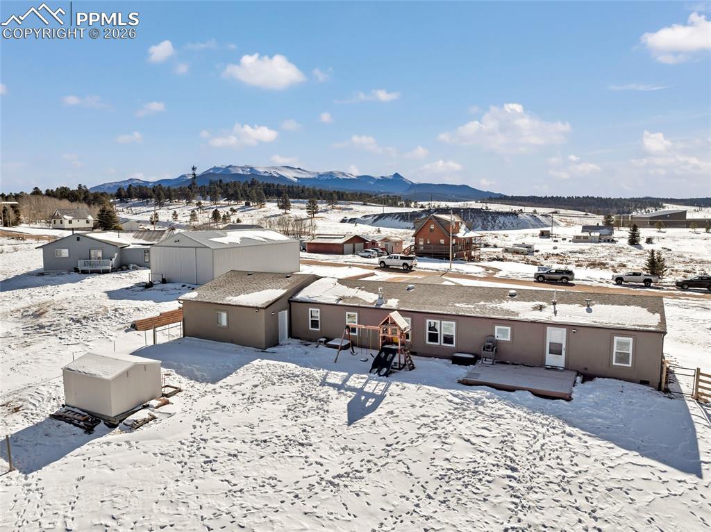 Image 35 of 36: Snowy aerial view featuring a mountain view