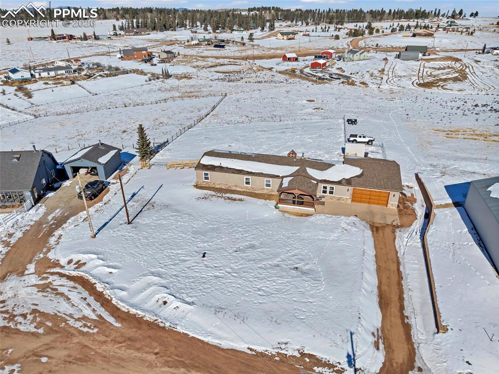 Image 5 of 36: Snowy aerial view with a residential view
