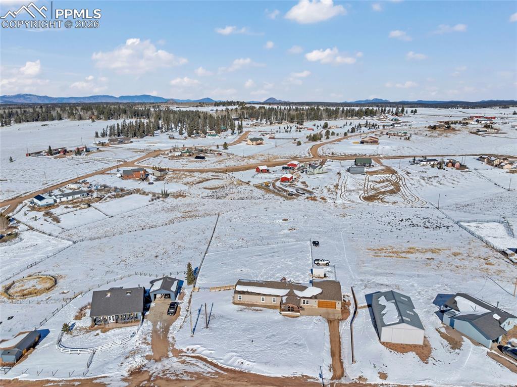 Image 7 of 36: Snowy aerial view with a mountain view and a residential view