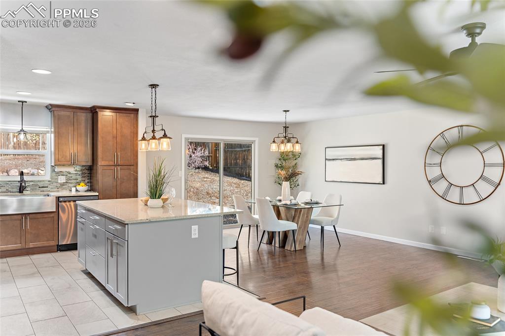 Image 16 of 38: Two tone kitchen featuring dual tone cabinets, a kitchen island, a breakfas