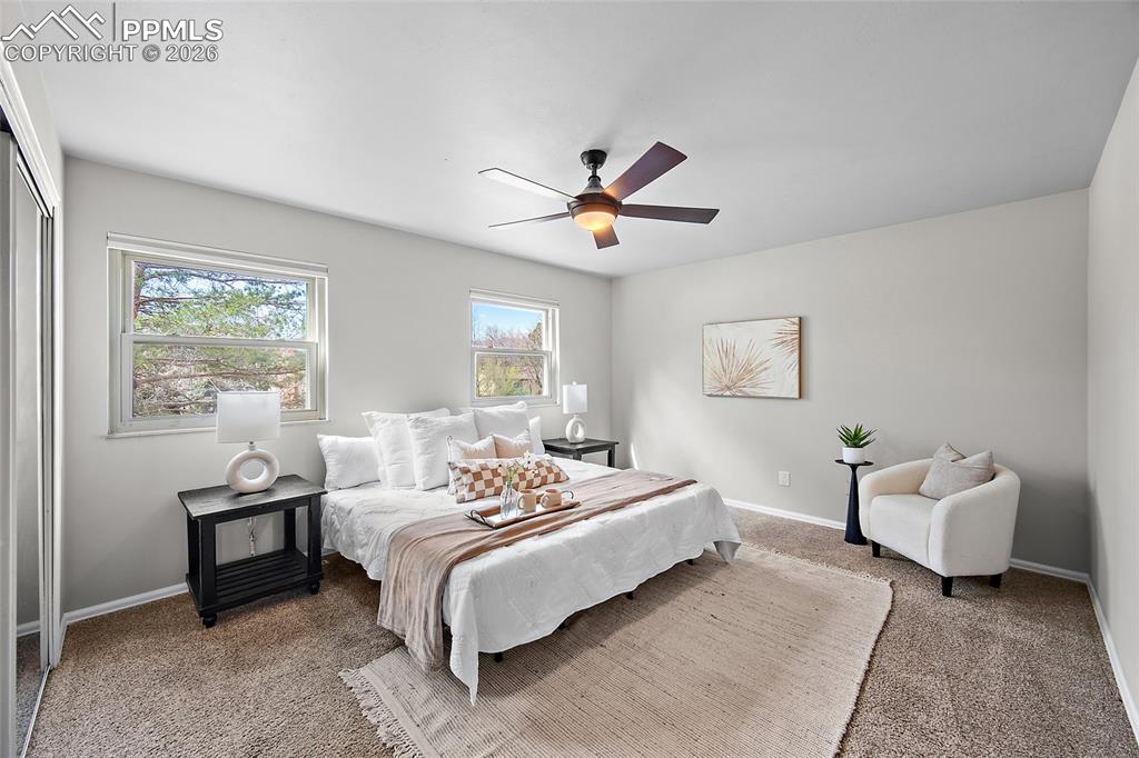 Image 17 of 38: Carpeted bedroom with baseboards and a ceiling fan