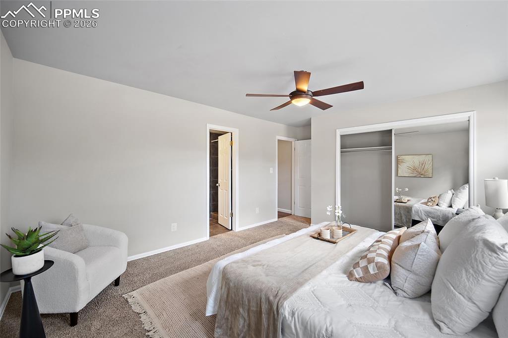 Image 18 of 38: Carpeted bedroom featuring a ceiling fan and a closet
