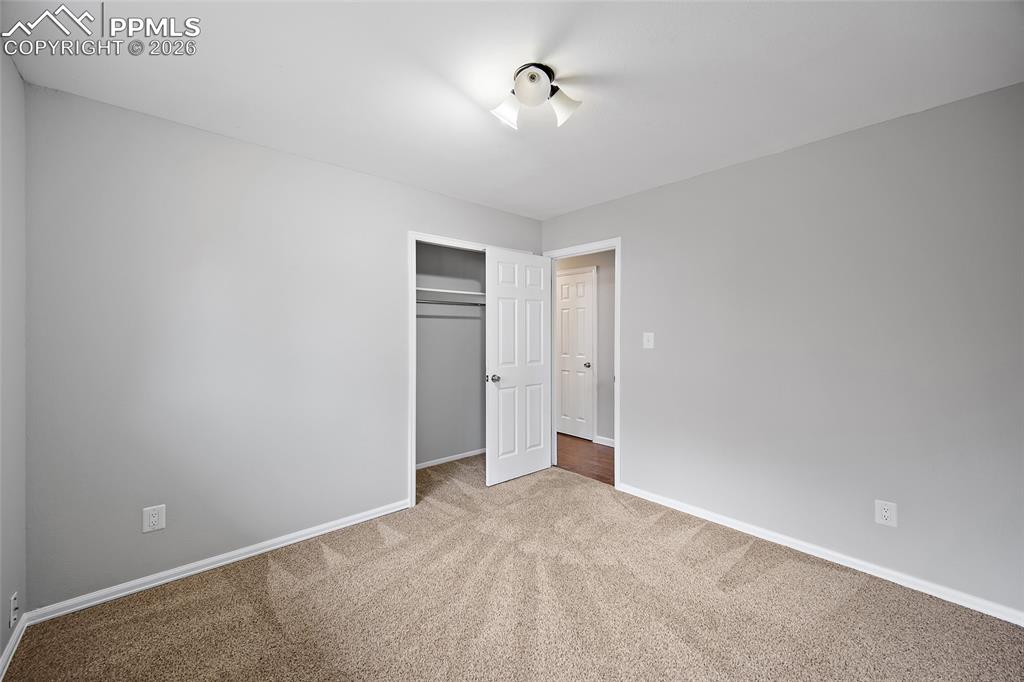 Image 29 of 38: Unfurnished bedroom featuring a closet and light colored carpet