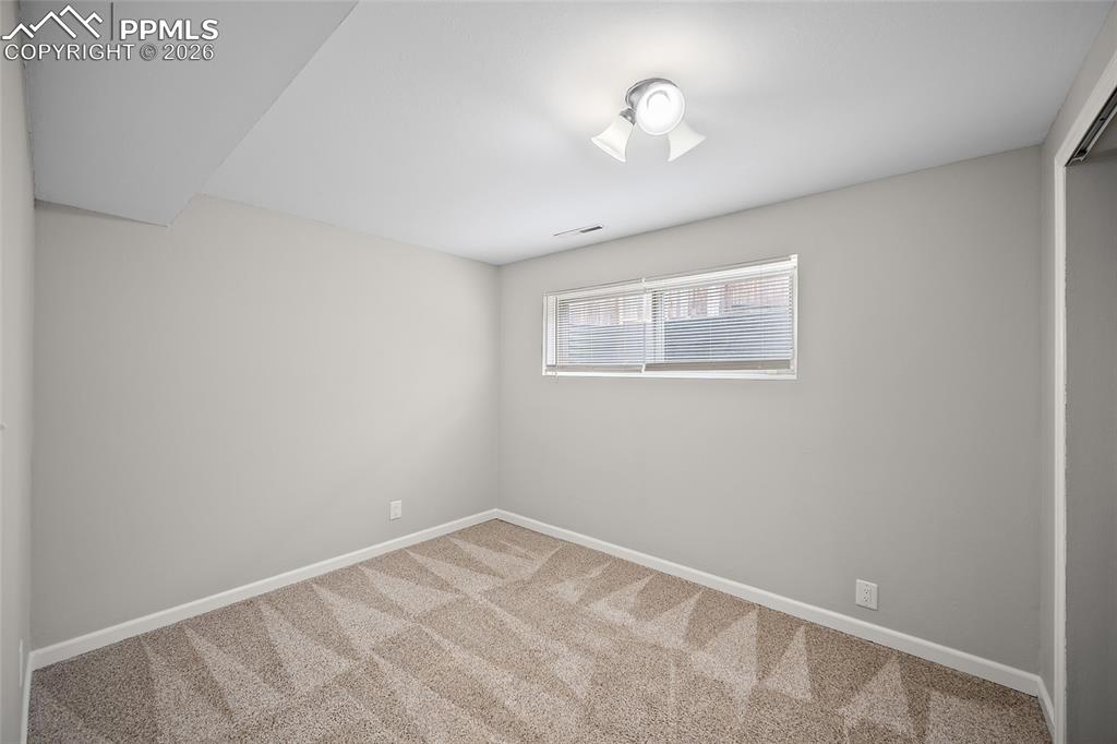 Image 30 of 38: Basement bedroom