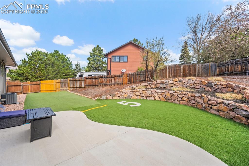 Image 33 of 38: Fenced backyard featuring a patio area