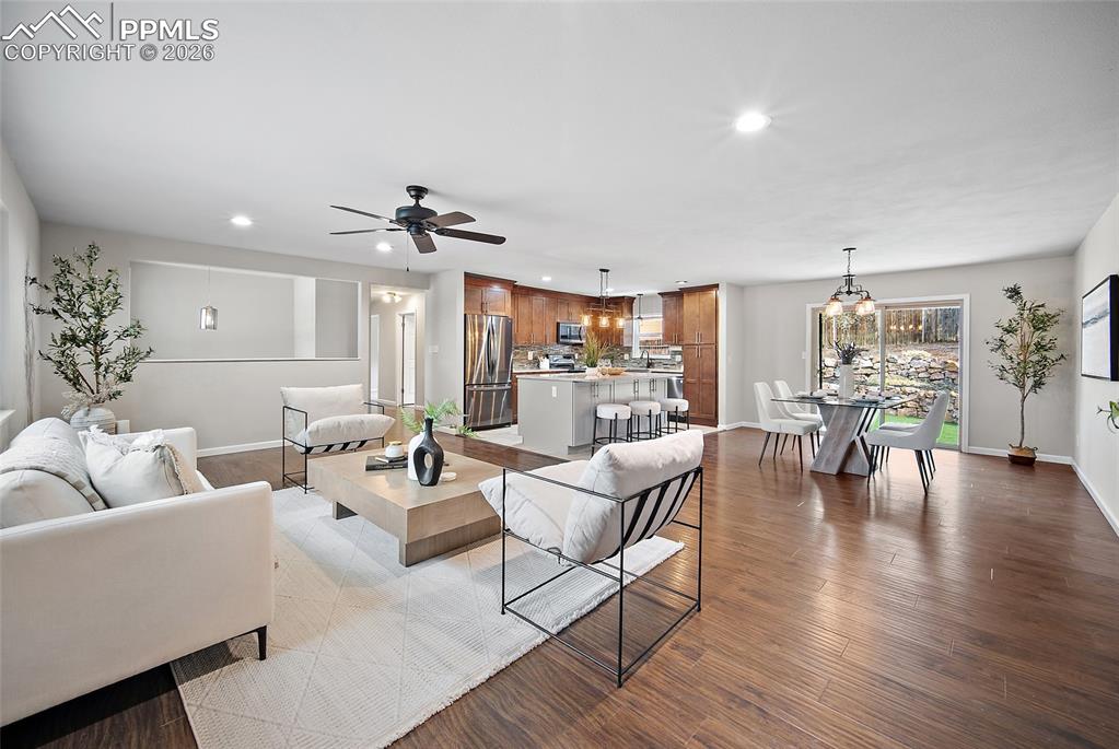 Image 5 of 38: Living area featuring recessed lighting, ceiling fan, and dark wood-style f