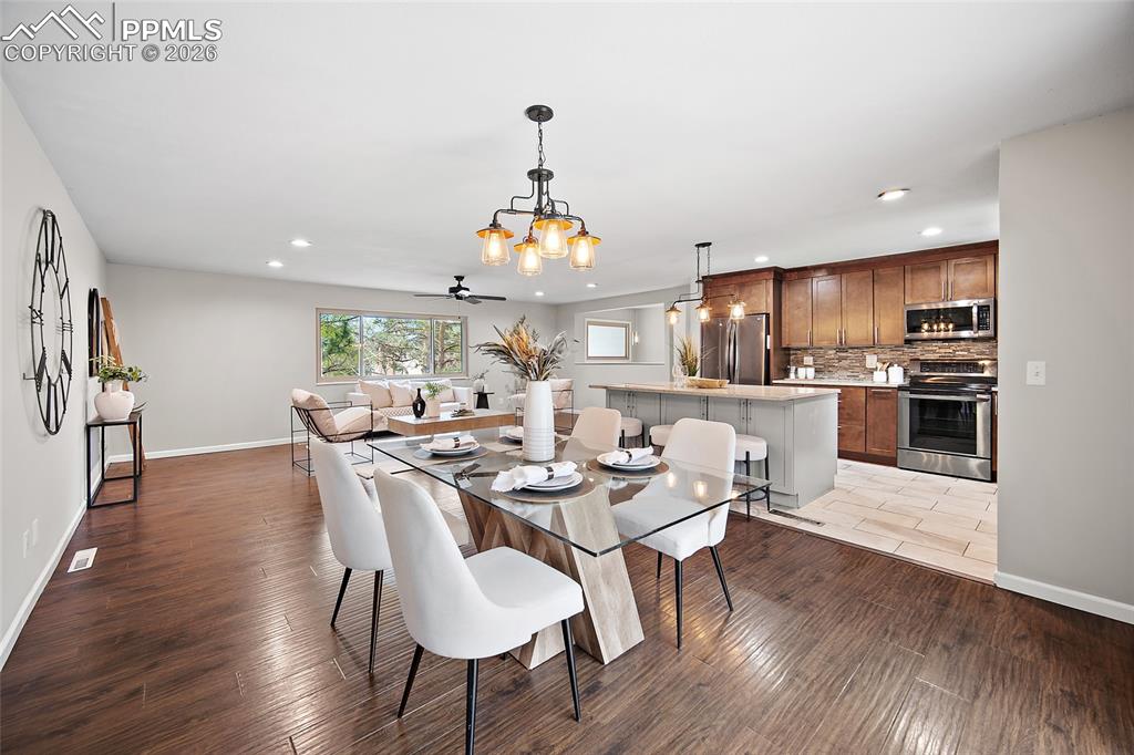 Image 9 of 38: Dining area featuring light wood-style floors, hanging lights, and ceiling 