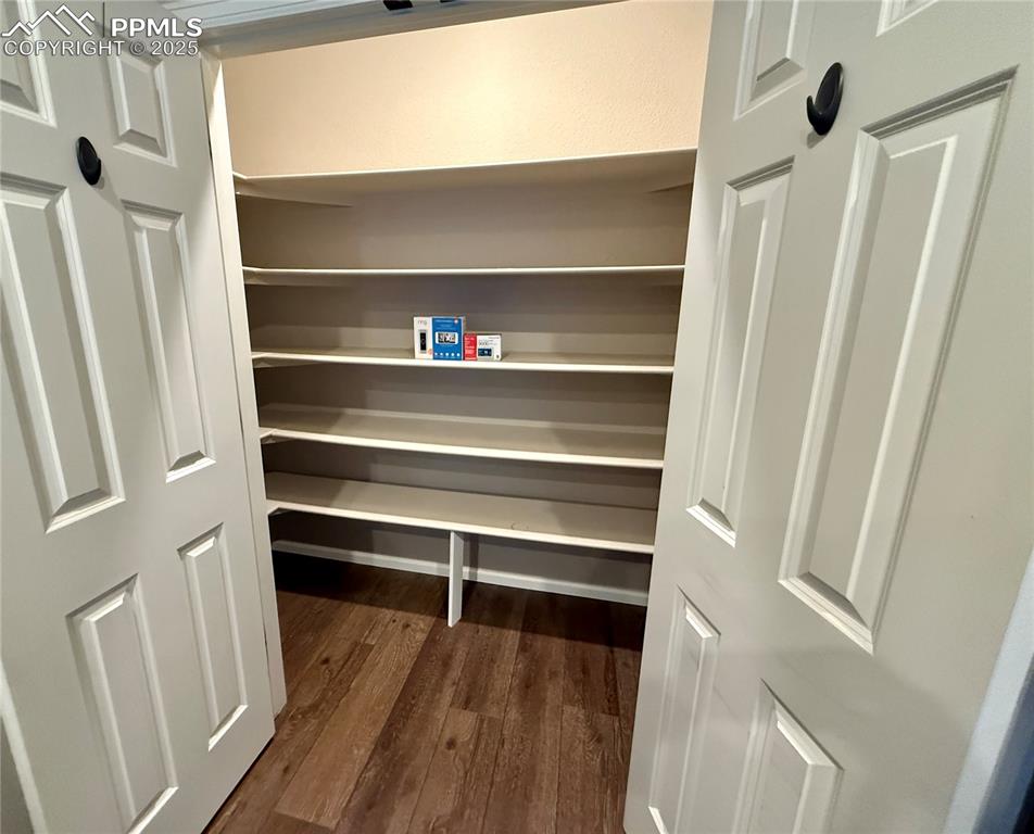 Image 12 of 41: large pantry with wooden shelves