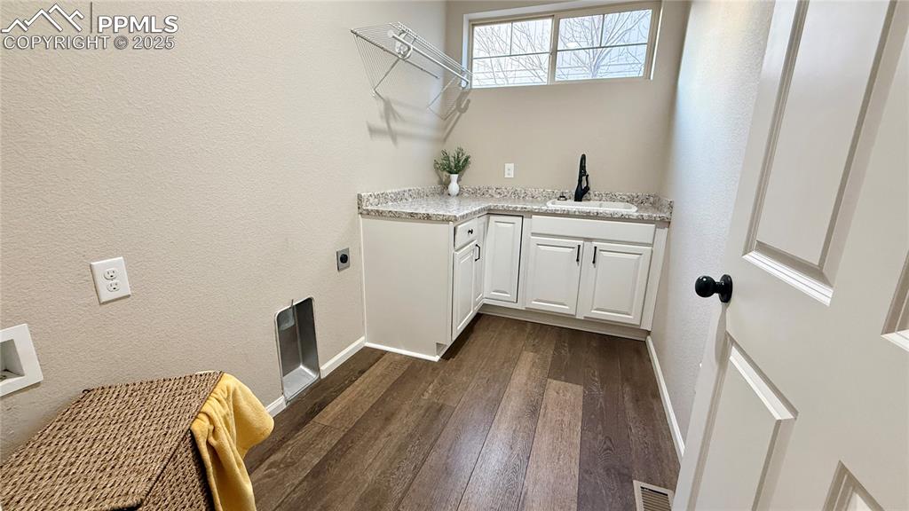 Image 24 of 41: laundry room with cabinets and sink on main level