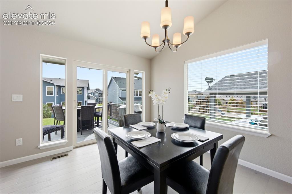 Image 12 of 45: Dining area just off the kitchen opens to the backyard patio.