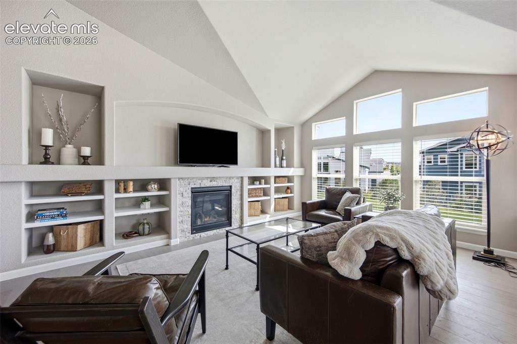 Image 14 of 45: Soaring ceiling and abundant windows in the living room