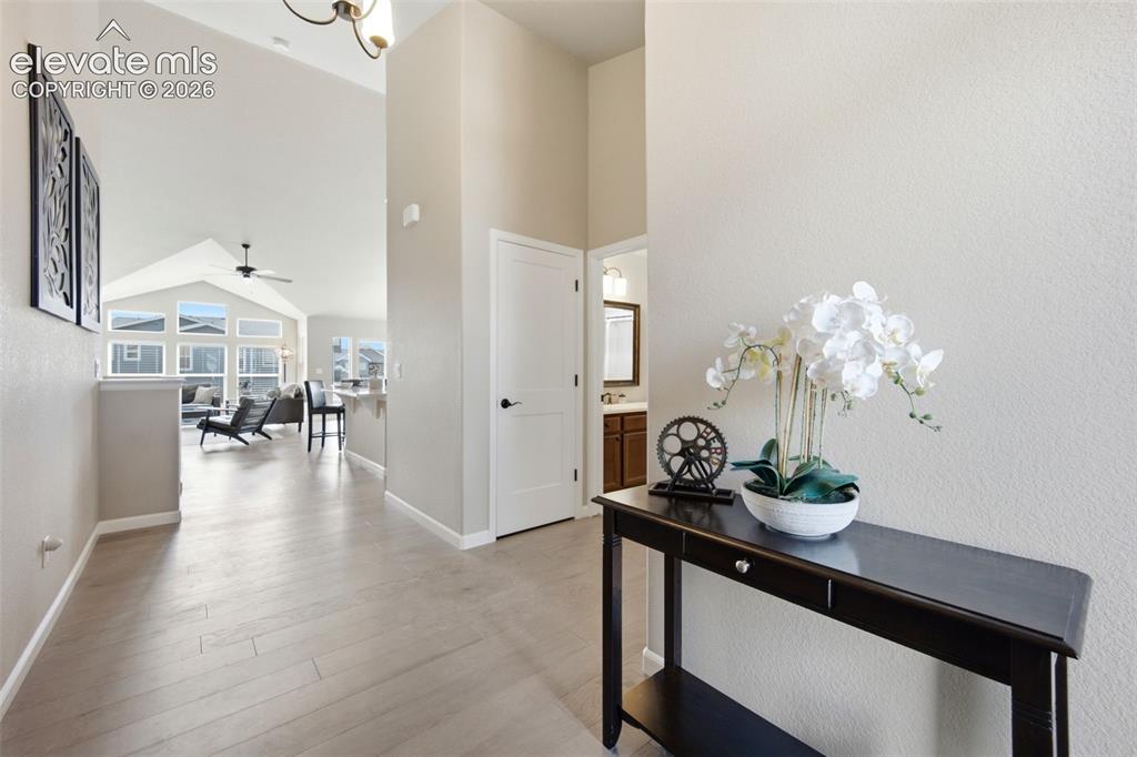 Image 3 of 45: Open and welcoming front entry with hickory floors and abundant light