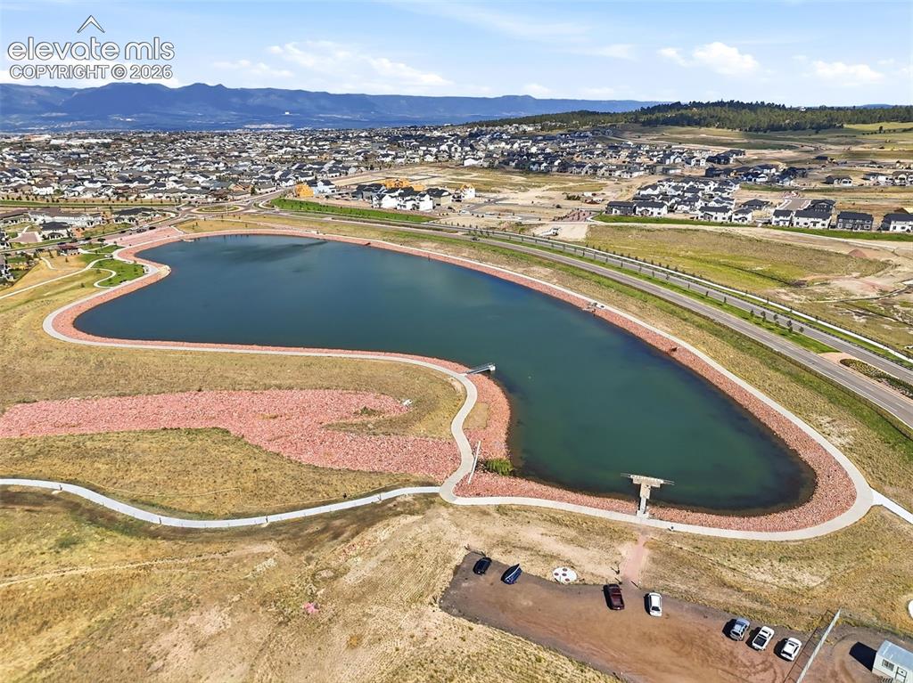 Image 43 of 45: Neighborhood pond with walking paths.