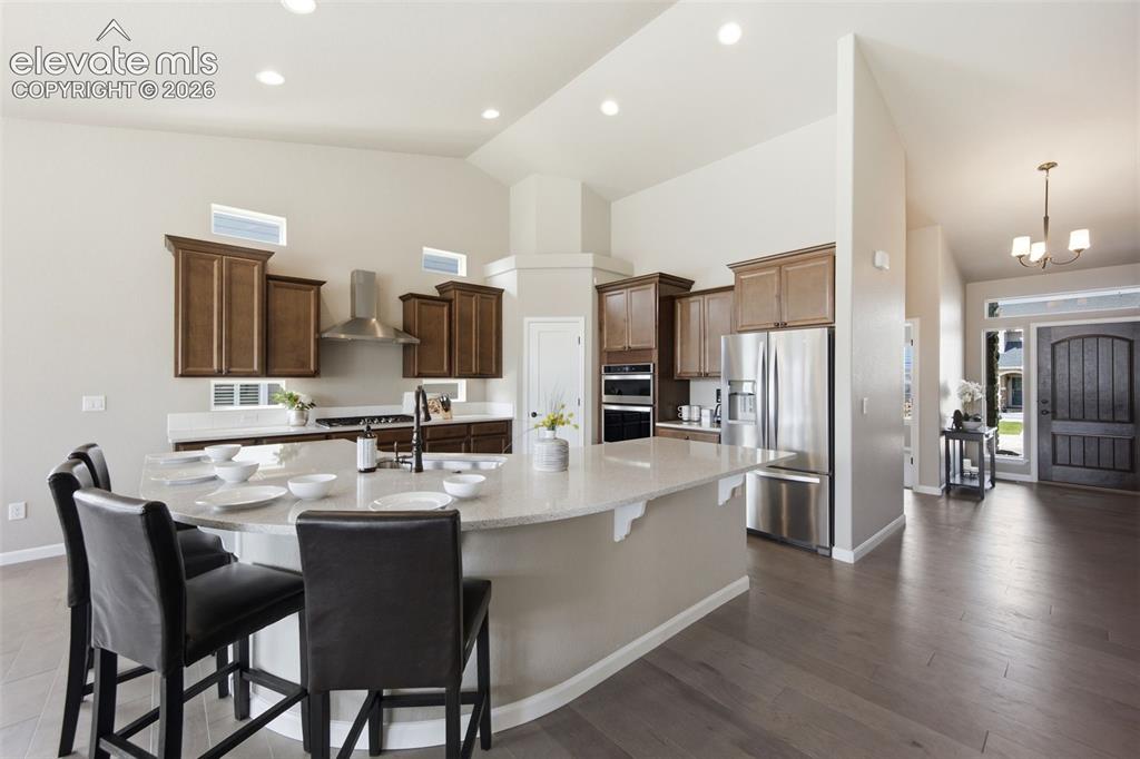 Image 6 of 45: Large island with counter seating and spacious eat-in nook as well.