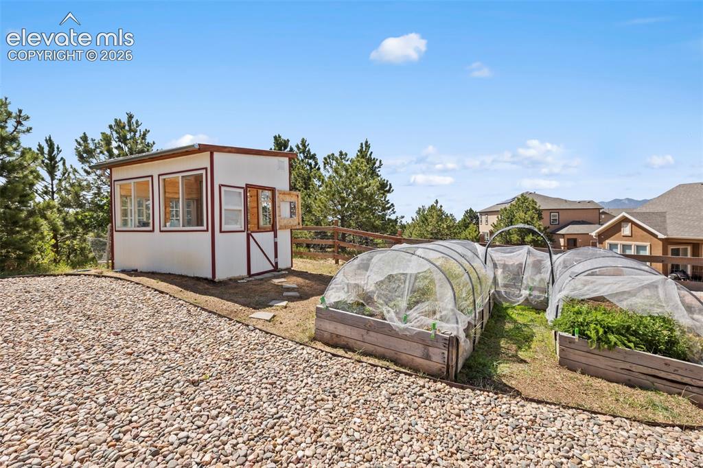 Image 42 of 50: included green house with irrigated garden beds