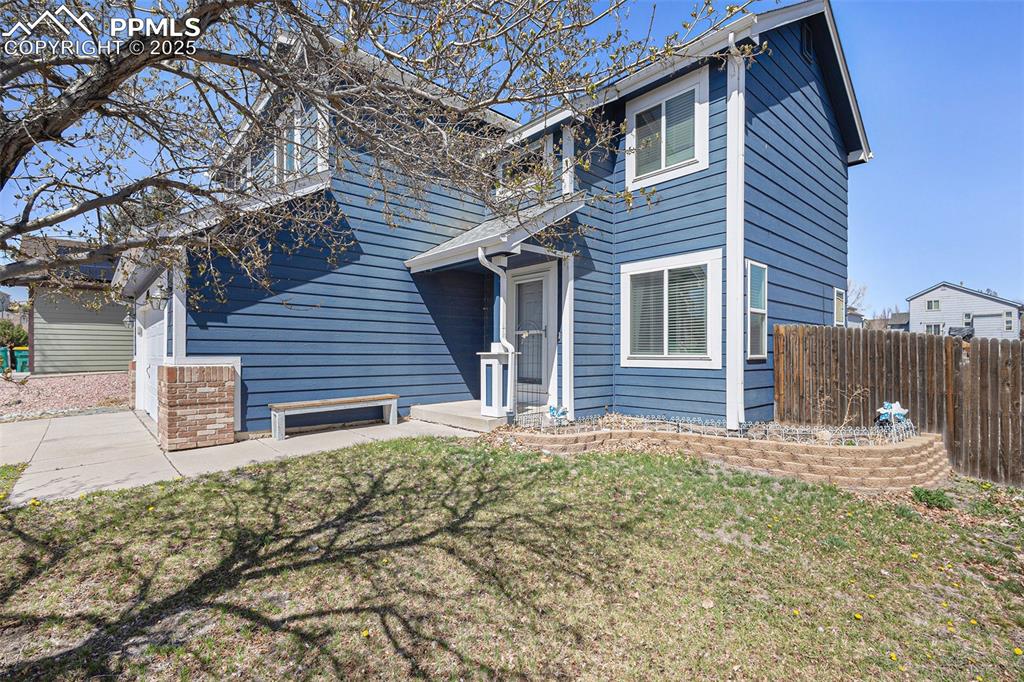 Image 20 of 21: Traditional-style home featuring a front yard and fence