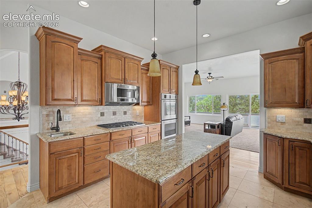 Image 15 of 50: Maple cabinetry, double ovens, gas cooktop, and generous prep space