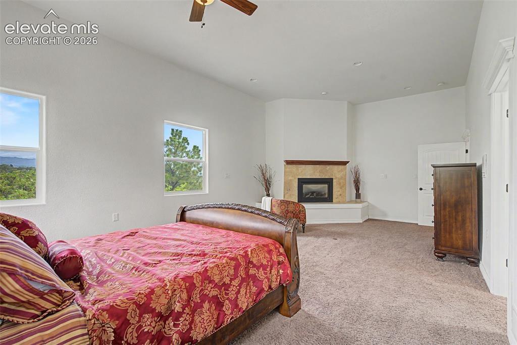 Image 19 of 50: Expansive primary suite with gas fireplace, sitting area potential, and mou
