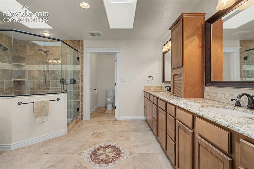 Image 23 of 50: Five-piece primary bath with dual vanities, oversized shower, soaking tub, 