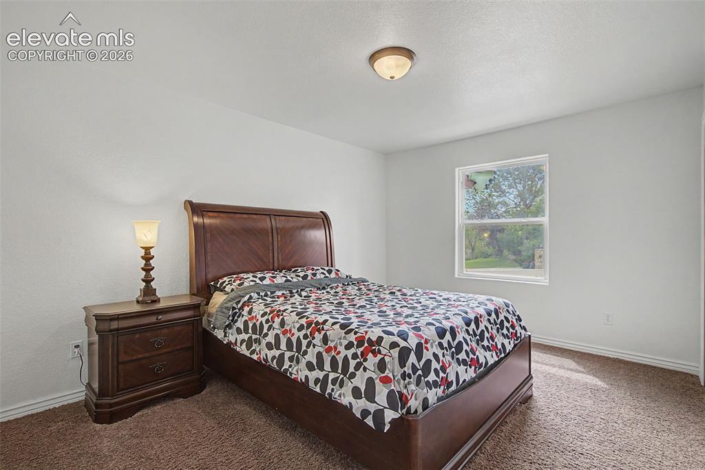 Image 26 of 50: Comfortable secondary bedroom with natural light and direct bathroom access