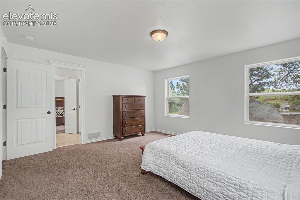 Image 29 of 50: Generous bedroom layout offering flexibility for guests, family members, or