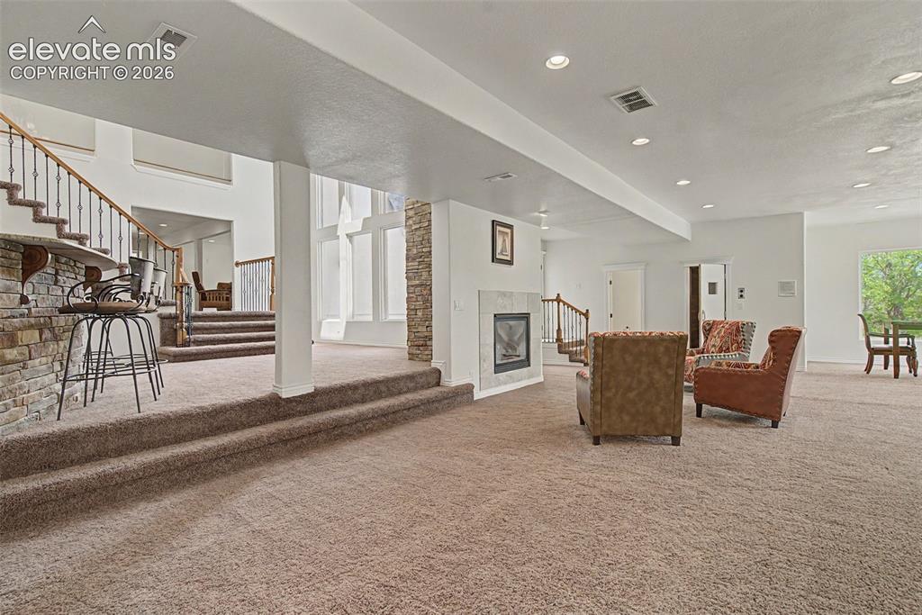 Image 39 of 50: Expansive lower-level living area featuring multiple gathering zones, a gas