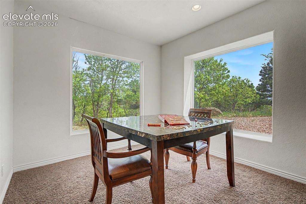 Image 40 of 50: Bright bonus space framed by oversized windows, ideal for hobbies, games, r