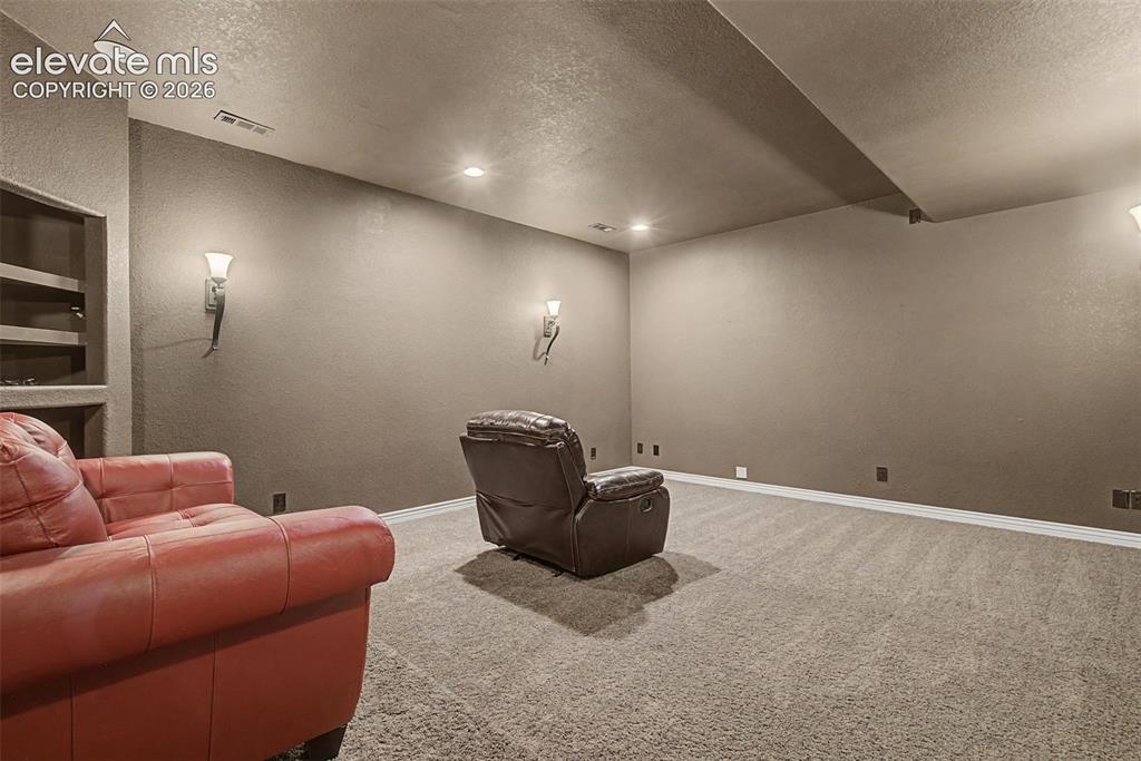 Image 42 of 50: Dedicated theater and media room offering space for movies, gaming, sports 