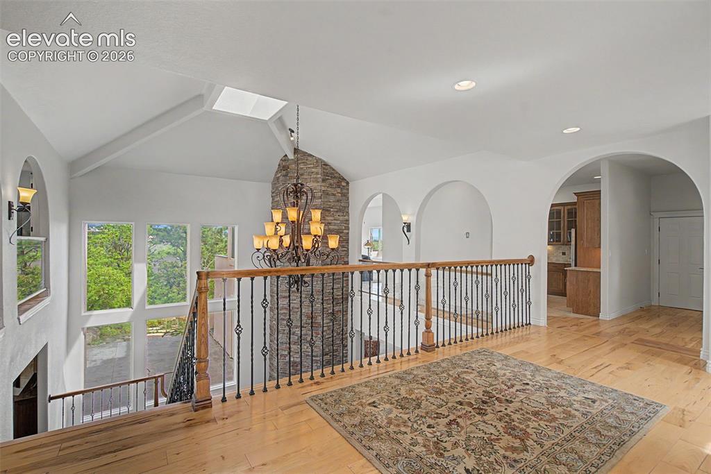 Image 6 of 50: Dramatic raised mezzanine foyer overlooking the lower level