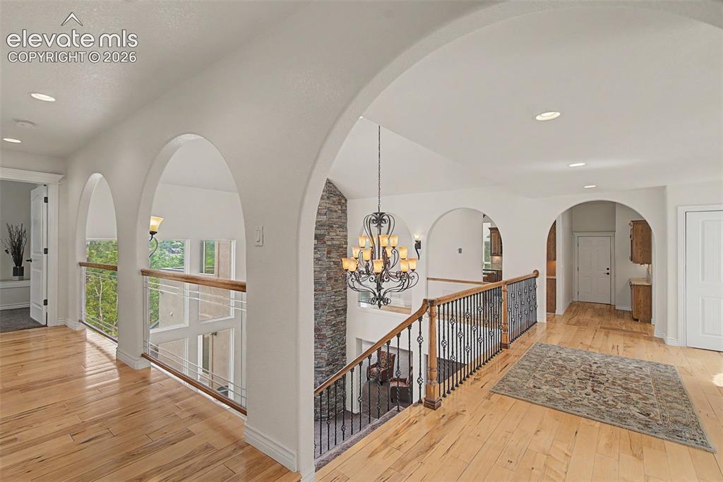 Image 8 of 50: Expansive upper-level foyer connecting the main living spaces