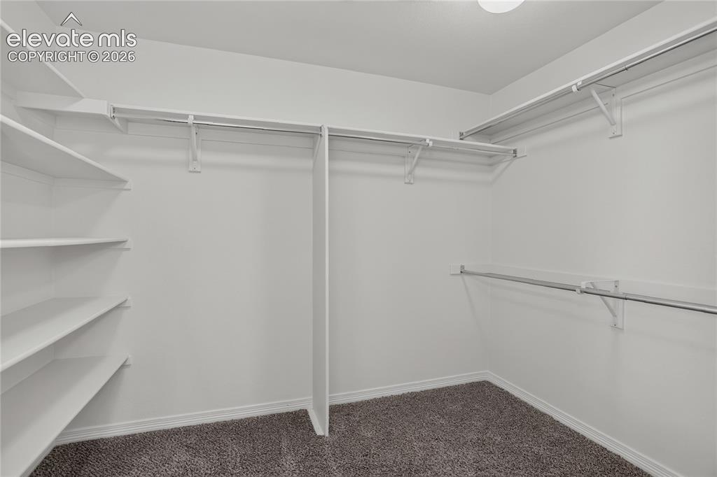 Image 16 of 23: Walk-in primary closet