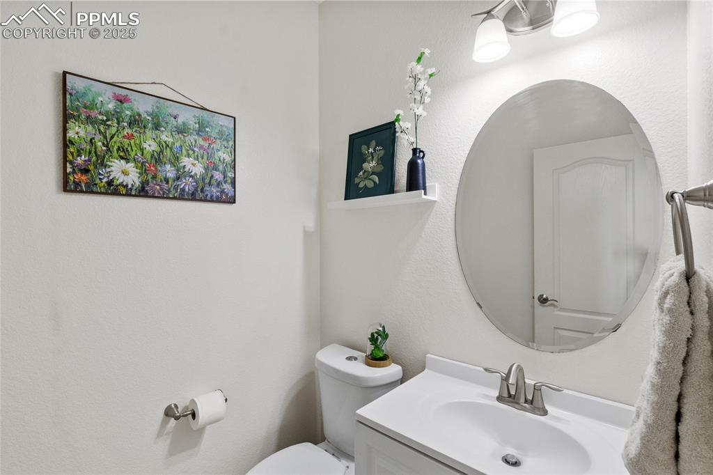 Image 12 of 36: Half bath with toilet and vanity