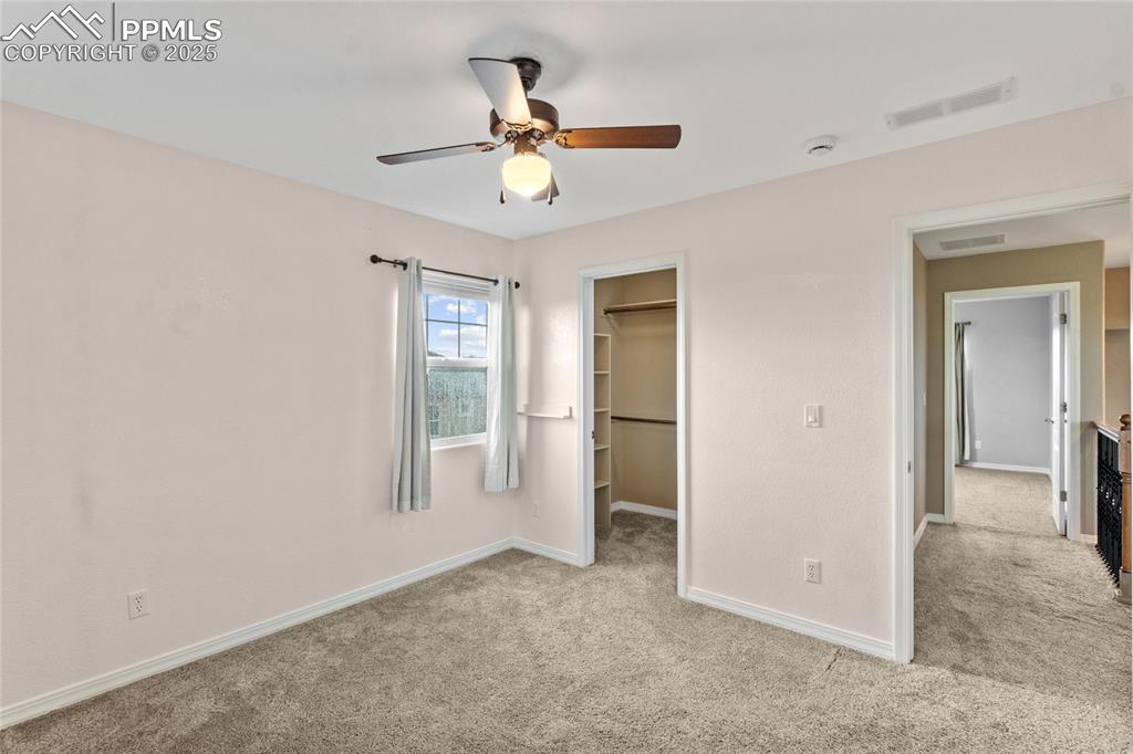 Image 15 of 36: Unfurnished bedroom featuring carpet floors, a spacious closet, a ceiling f