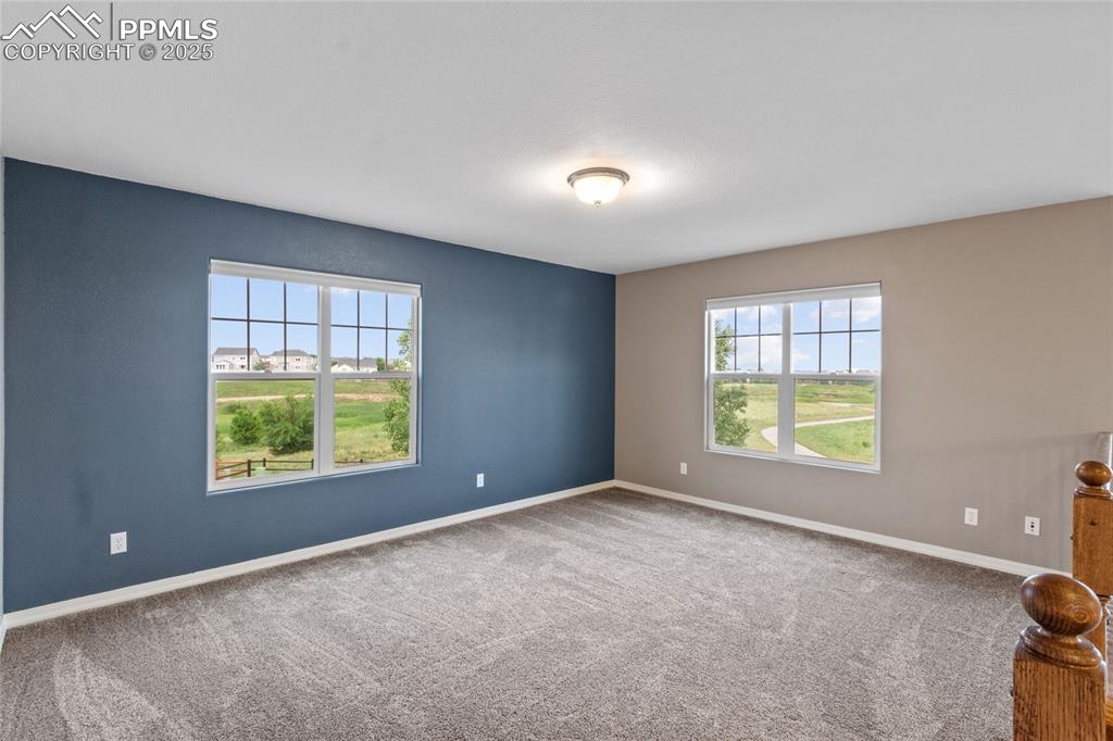 Image 16 of 36: Spare room featuring carpet and baseboards