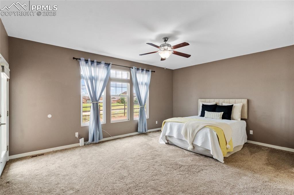 Image 22 of 36: Bedroom with carpet flooring and a ceiling fan