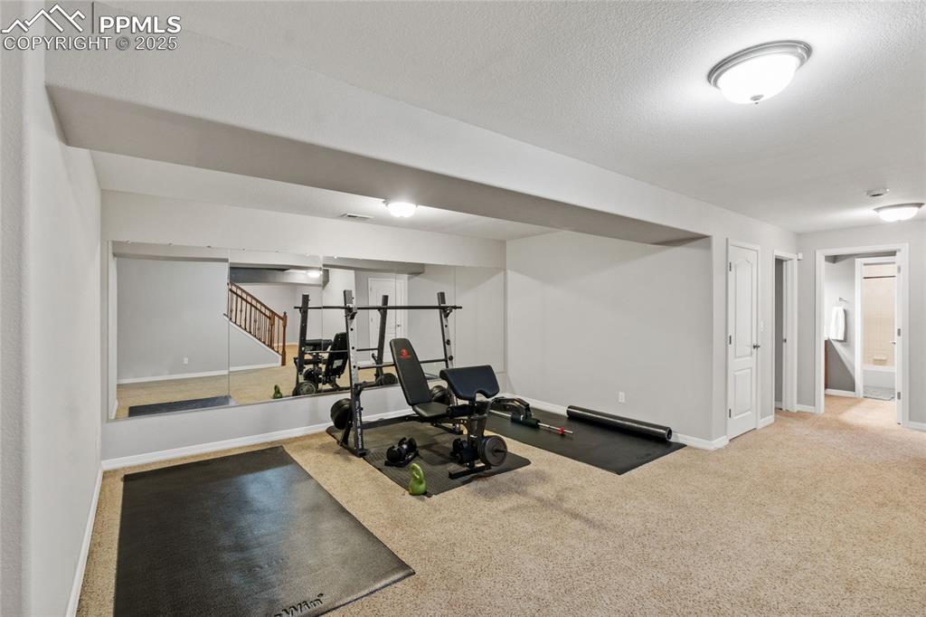 Image 26 of 36: Exercise area featuring baseboards and carpet flooring