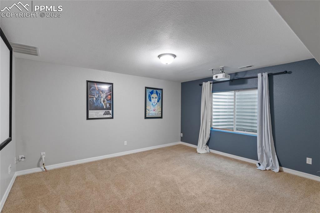 Image 27 of 36: Unfurnished room featuring light colored carpet and a textured ceiling