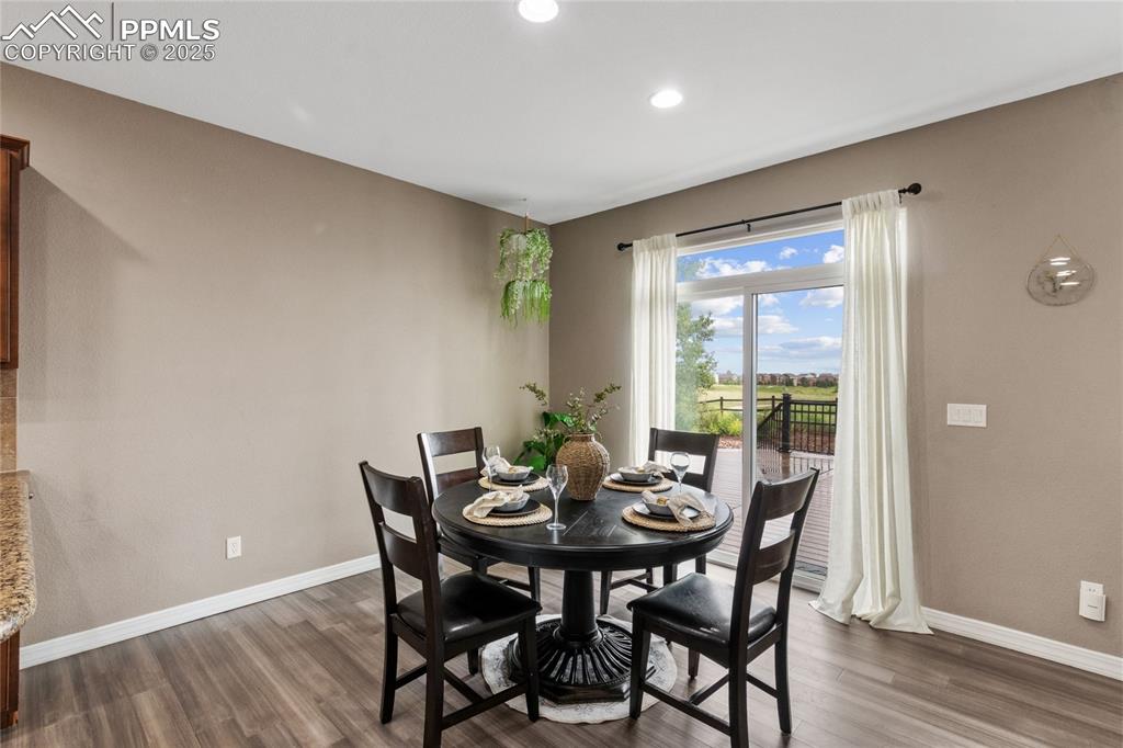 Image 7 of 36: Dining room featuring dark wood finished floors and recessed lighting