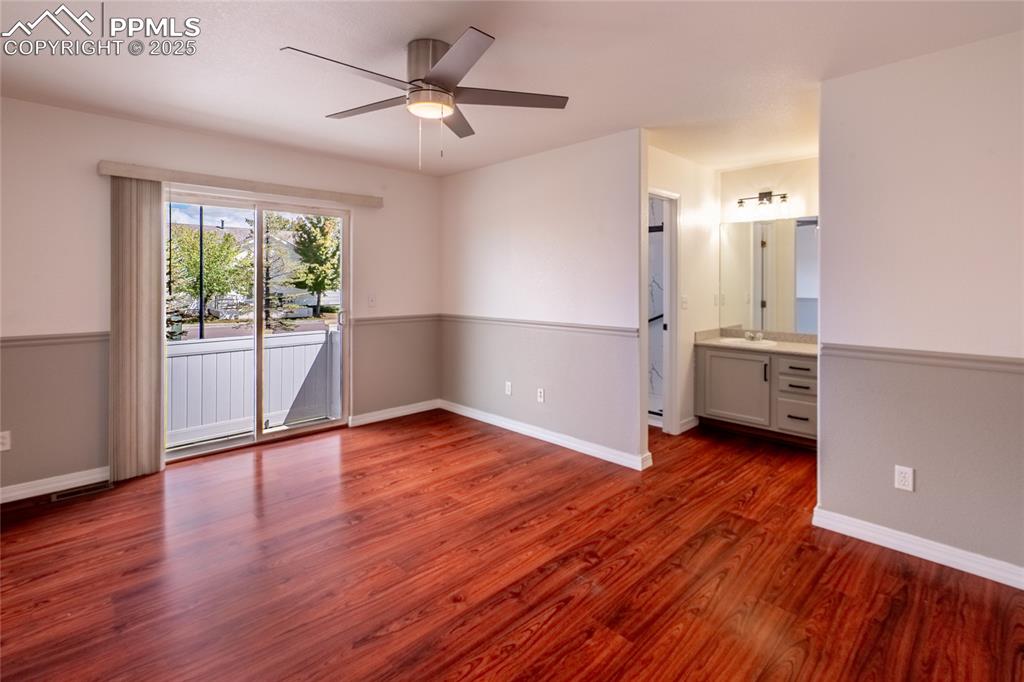 Image 14 of 47: Unfurnished bedroom featuring access to outside, dark wood-style flooring,