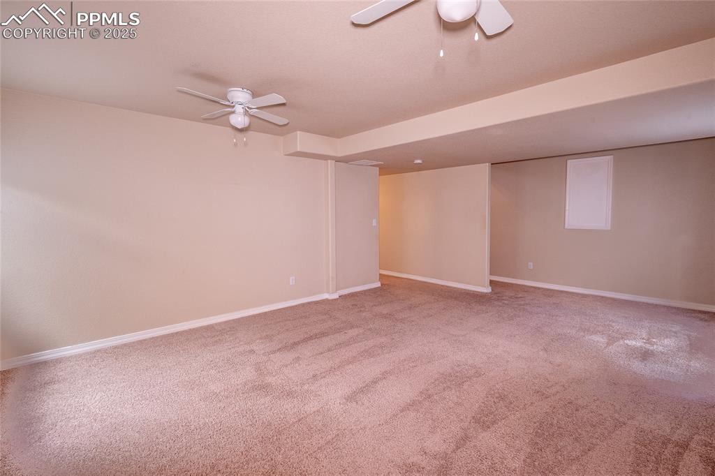 Image 18 of 47: Spare room featuring a ceiling fan and light colored carpet