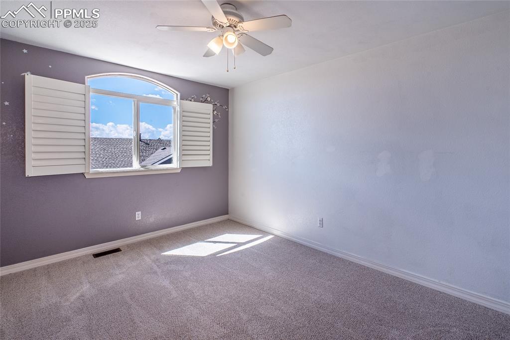 Image 24 of 47: Carpeted empty room featuring baseboards and ceiling fan