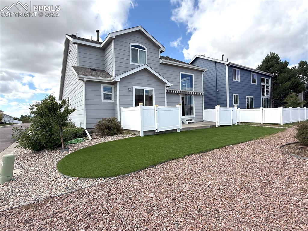 Image 40 of 47: Rear view of house featuring a wooden deck